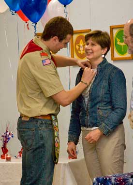 Ryan Williams and Evan Cochrane are awarded Eagle Scout rankings in a ceremony on June 10. At left, Willaims gives his mother, Alice Williams, a pin for her support. (Photo by Tyler Papazian)